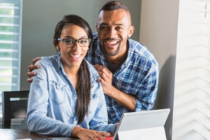 Couple sitting with computer at the table 